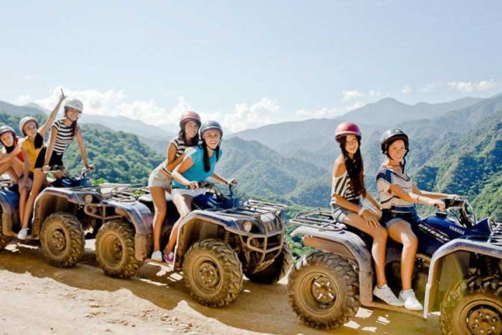 a group of people riding on the back of a truck