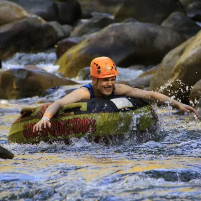 a man standing next to a body of water