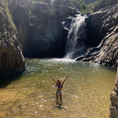 a man standing next to a body of water