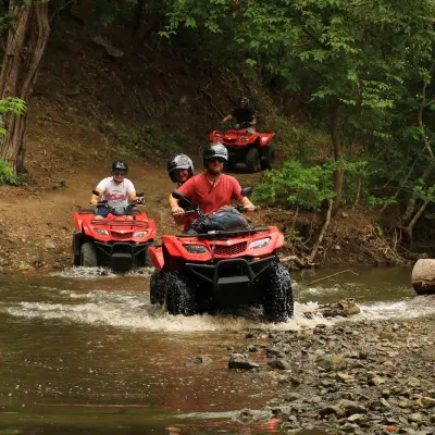 a man riding a motorcycle down a river