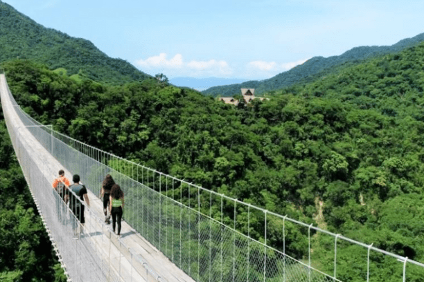 a group of people walking on a bridge