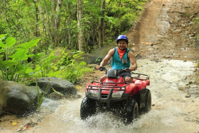 a man riding a bike down a dirt road