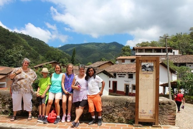 a group of people standing in front of a mountain
