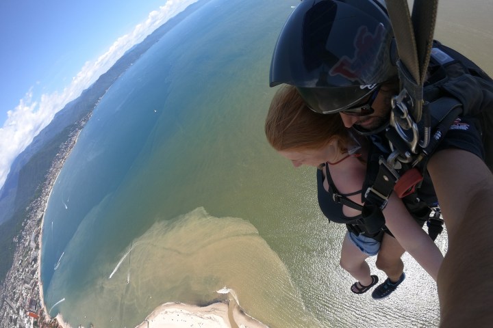 a young girl riding a wave on a surfboard in the water