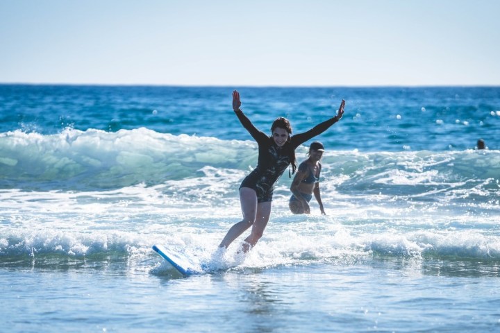 a man riding a wave on a surfboard in the ocean