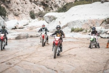 a group of people riding on the back of a motorcycle