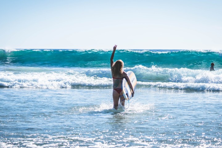 a man riding a wave on a surfboard in the ocean