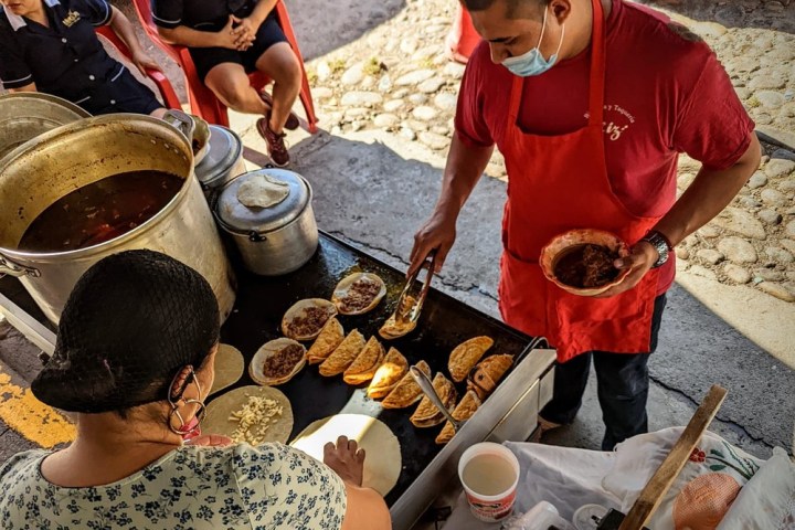 a group of people sitting at a table with food